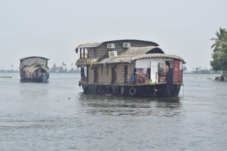 Boats on the Ganges river at misty sunrise in Varanasi, India