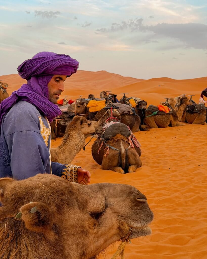Portrait of a traveller in a deep blue Saharan turban against a clear sky