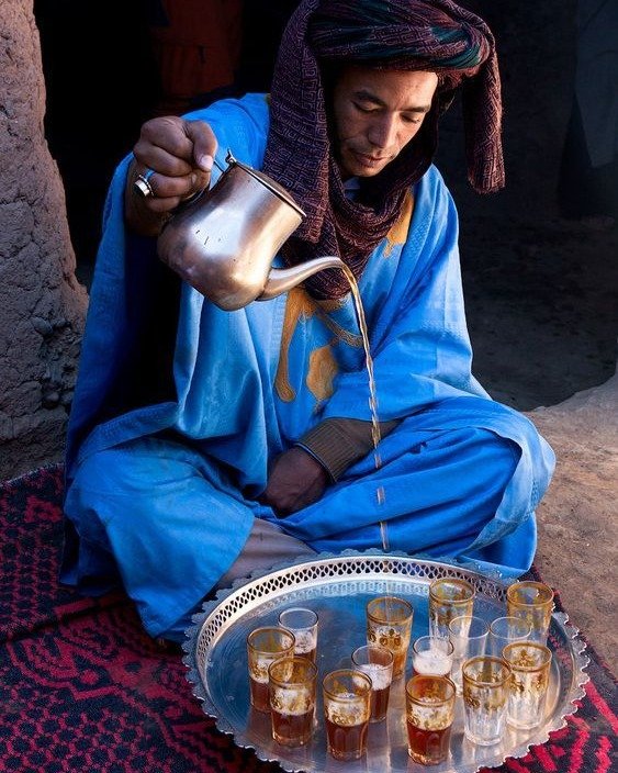 Sahara 8 Mint tea poured beside a campfire as the sun sets over the Sahara dunes